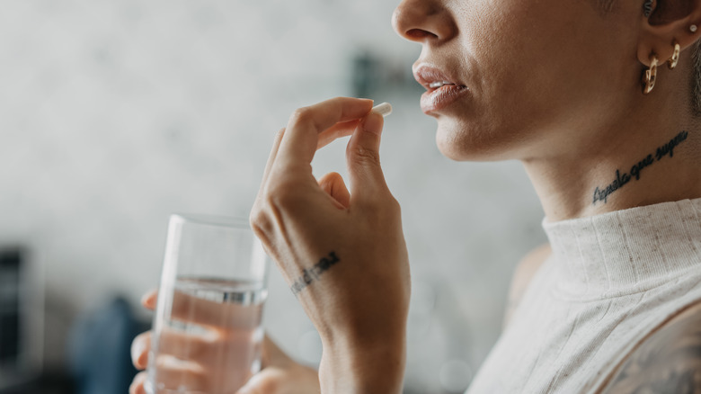 Woman taking ibuprofen