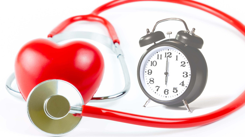 Heart with stethoscope and alarm clock