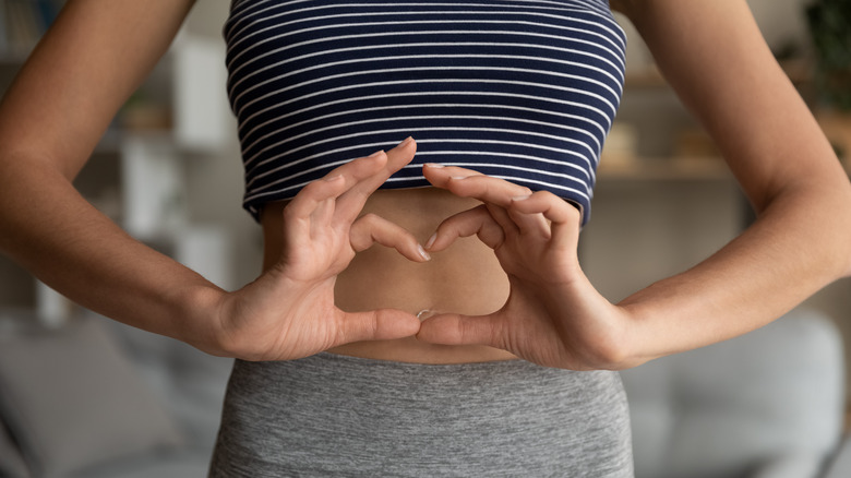 Woman with heart over abdomen