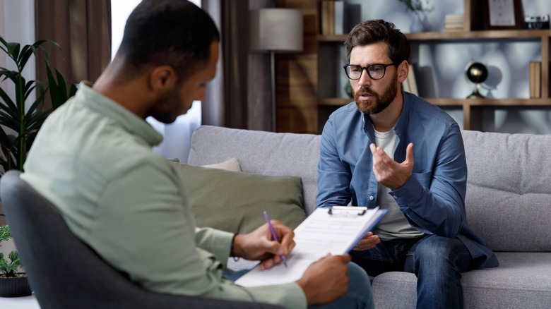 man speaking with mental health professional