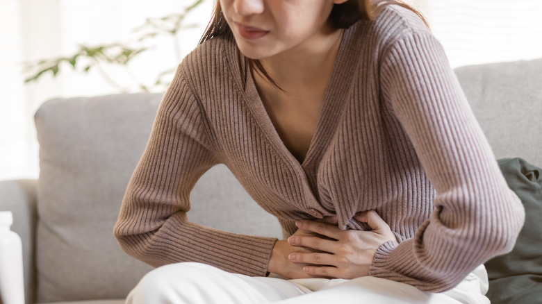 Woman holding her stomach in pain