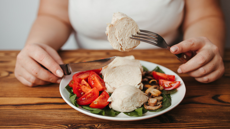 A woman eats a low-calorie meal