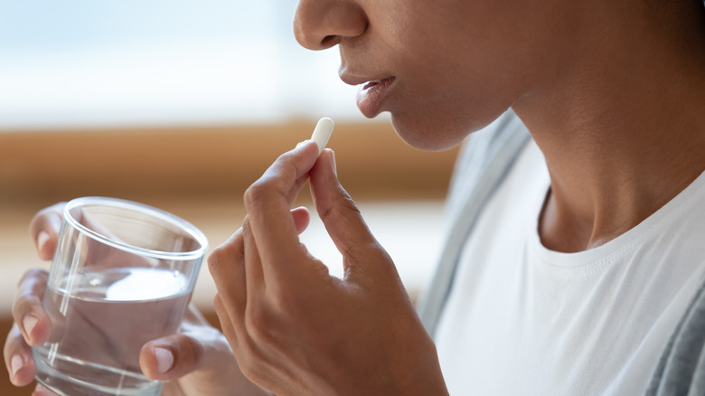 woman taking a pill