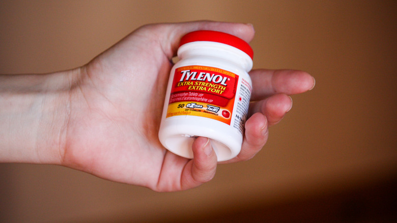 bottle of Tylenol held in hand