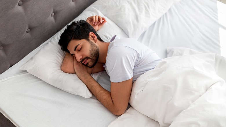 A man sleeps in bed