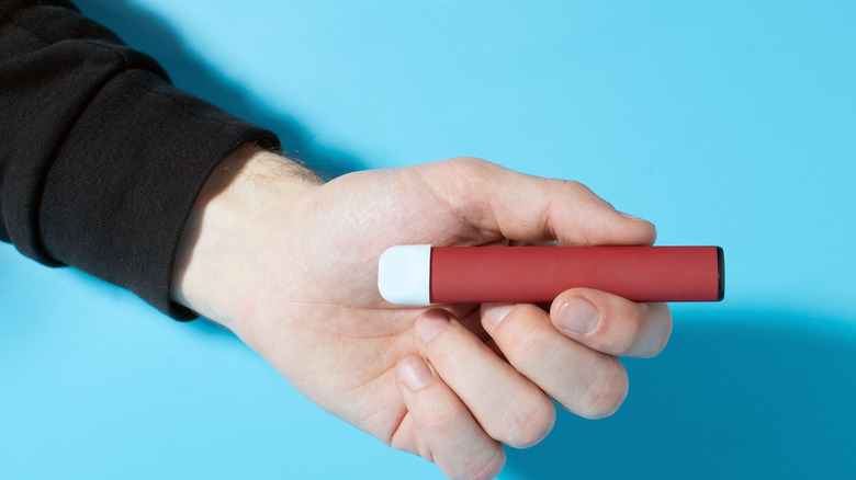 Closeup of disposable electronic cigarette in hand