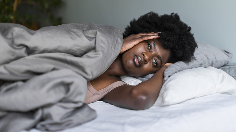 woman in bed experiencing insomnia