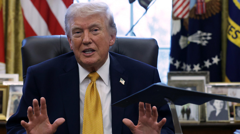 President Donald Trump speaking to the media after signing a document during a White House signing ceremony in the Oval Office of the White House
