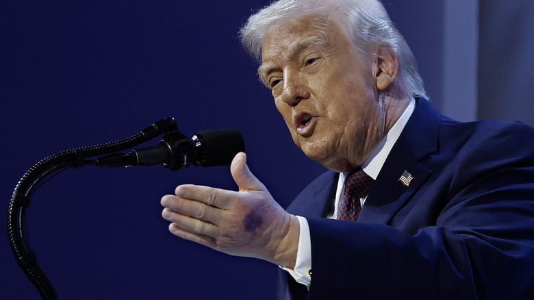 President Donald Trump gesturing during a signing ceremony for the "Board of Peace" at the World Economic Forum (WEF)