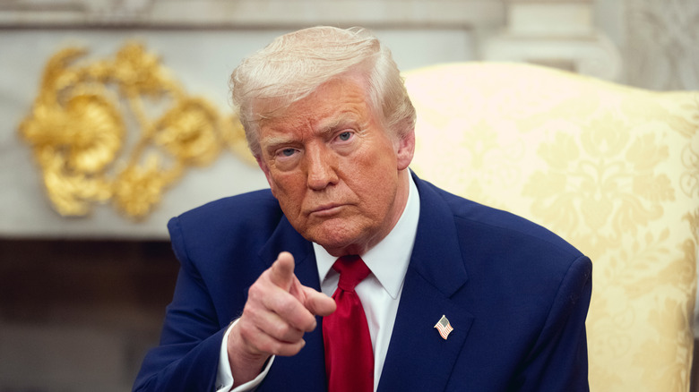 Donald Trump seated in Oval Office