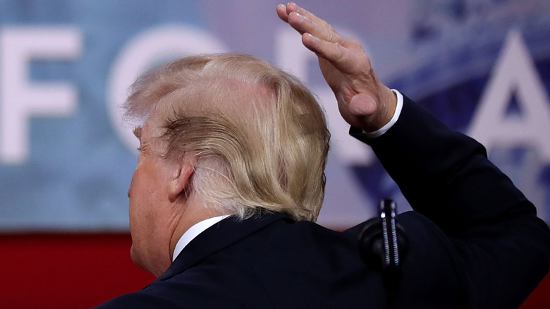 President Donald Trump joking about covering his bald spot while addressing the Conservative Political Action Conference at the Gaylord National Resort and Convention Center