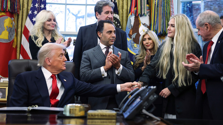 President Donald Trump shaking hands with Erika Kirk, the wife of the late conservative activist and media personality Charlie Kirk, during the swearing-in ceremony of U.S. Ambassador to India Sergio Gor in the Oval Office of the White House