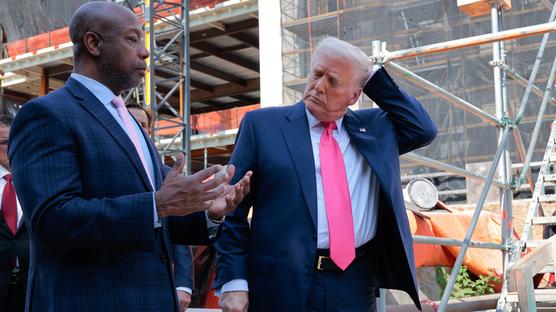 Donald Trump and Tim Scott talking to media while touring the Federal Reserve headquarters renovation project