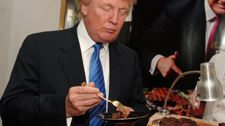 Donald Trump with a fork and a steak on a plate