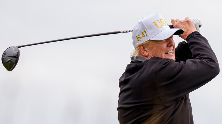 President Donald Trump teeing off at a new 18-hole course at Trump International Golf Links