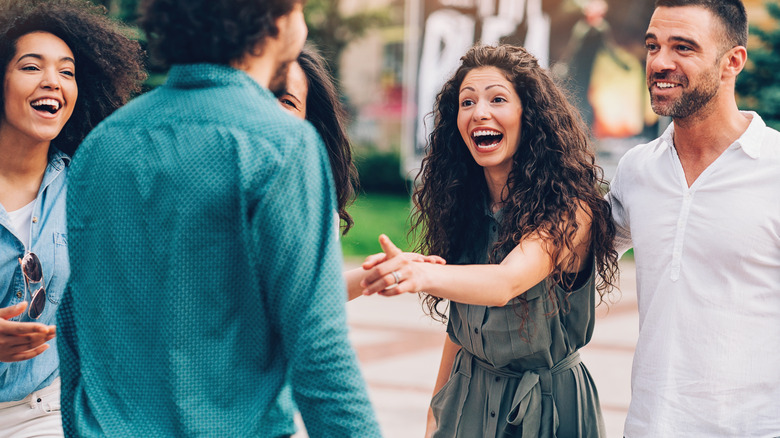 Friends laughing together outdoors