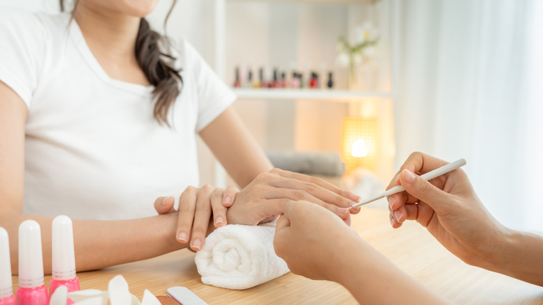 A woman's hands getting a professional manicure