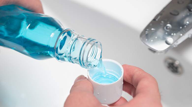 Mouthwash being poured into a cup