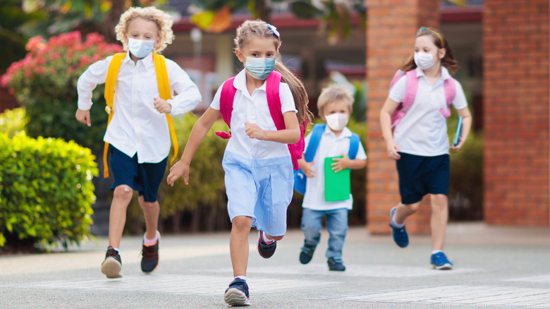 kids running with masks and backpacks