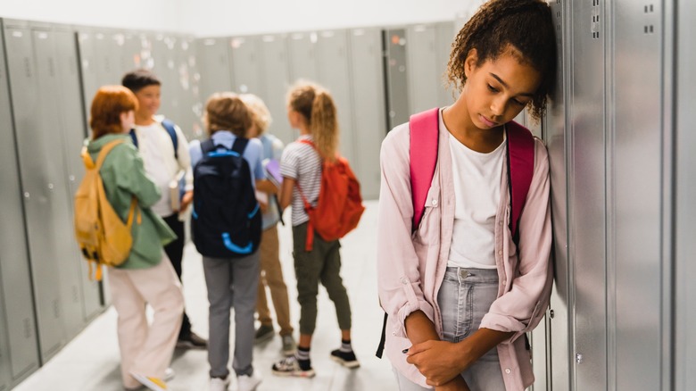 girl looking lonely and sad at school
