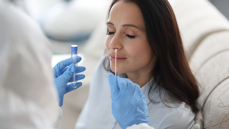 A woman getting swabbed for COVID