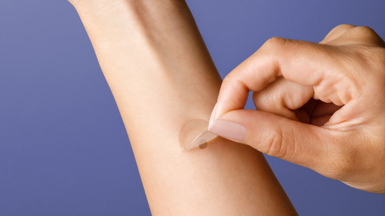 DermTech's smart sticker being applied to a mole