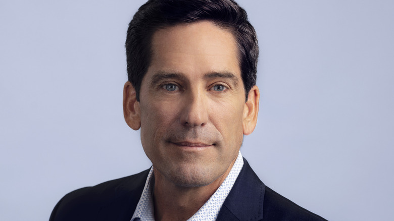 Headshot of Dr. John Dobak in dress shirt and suit jacket