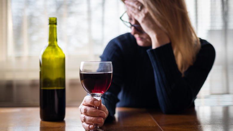 Woman drinking wine alone