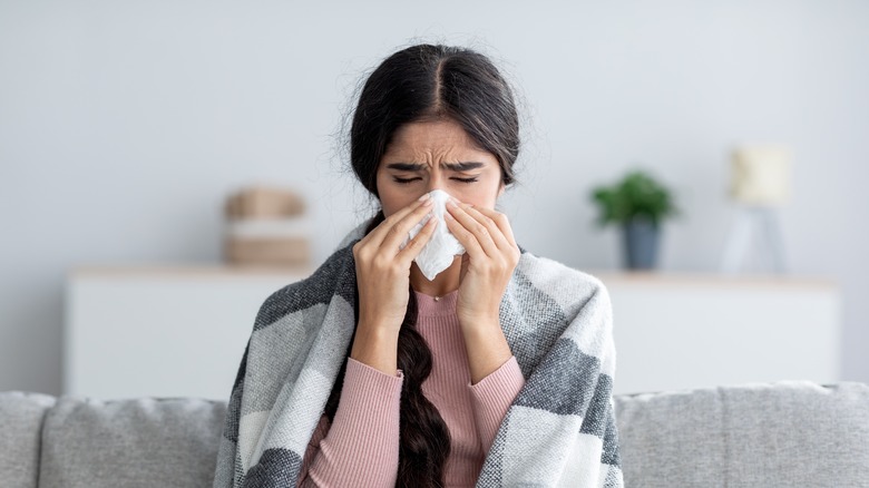 Woman blowing her nose