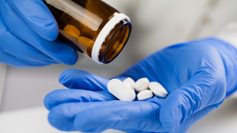 Paxlovid tablets being poured out of bottle