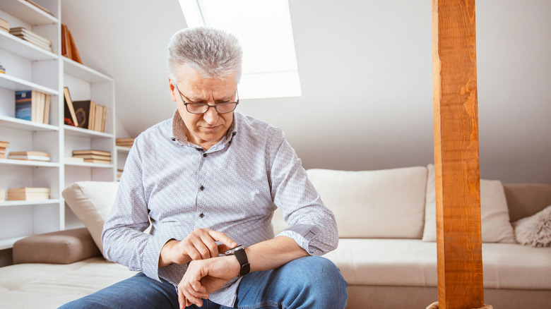 Man looking at watch measuring heart rate