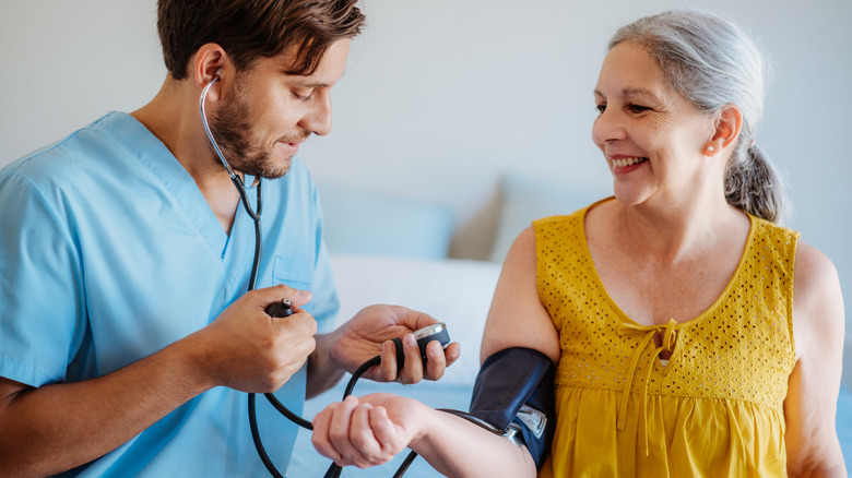 older woman getting blood pressure reading taken