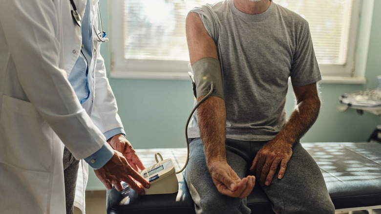 man getting blood pressure taken