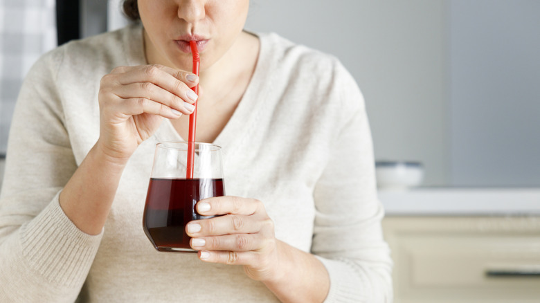 glass of red grape juice on a wooden table