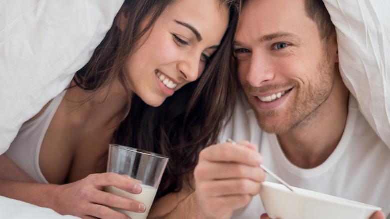 Woman drinking milk in bed