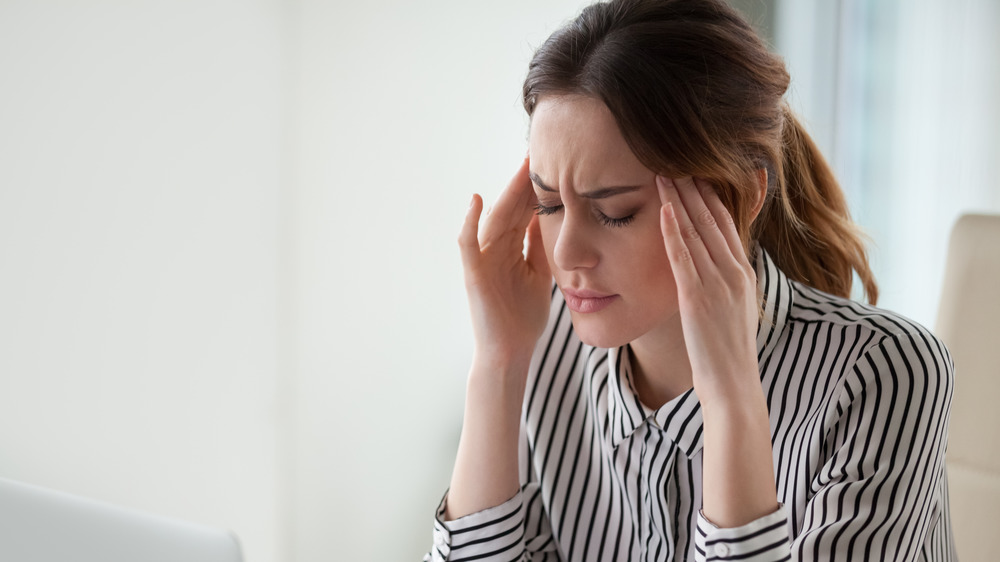 Woman holding her head