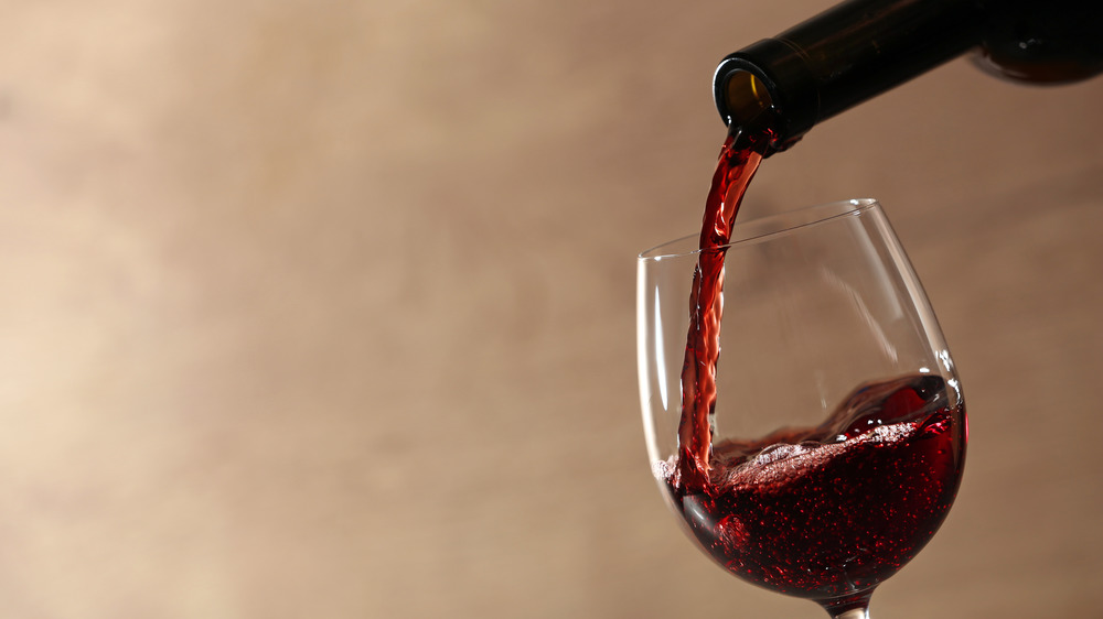 filling glass with red wine 