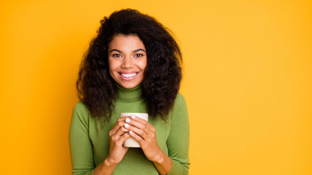 Black woman holding a mug