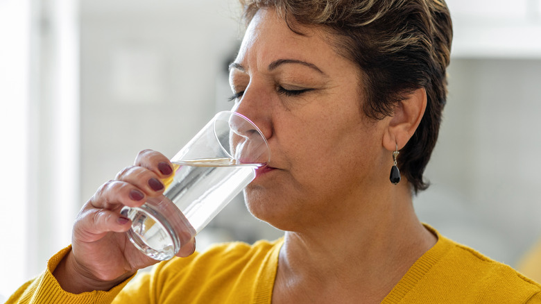 Older woman drinking glass of water