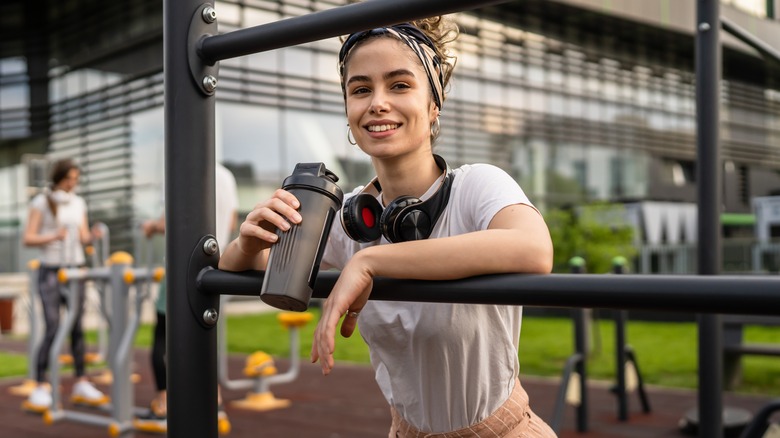 woman taking a drink before working out