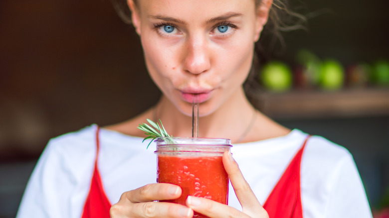 woman drinking vegetable juice