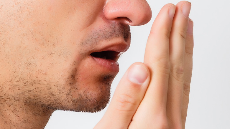 Man checking for bad breath