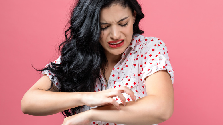 Skin being analyzed with magnifying glass