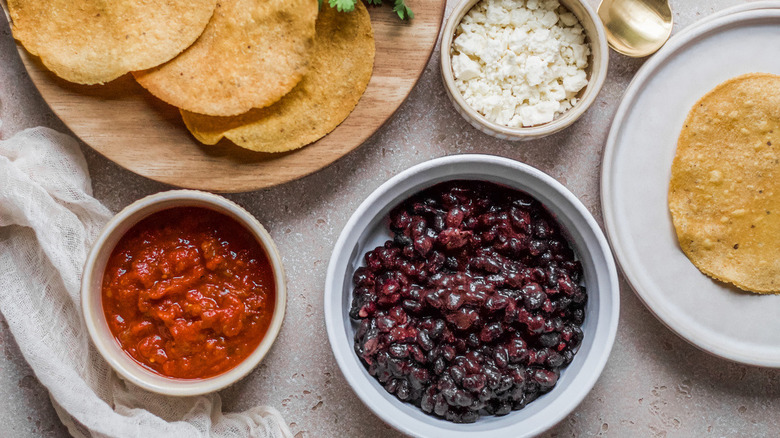assembling easy black bean tostadas
