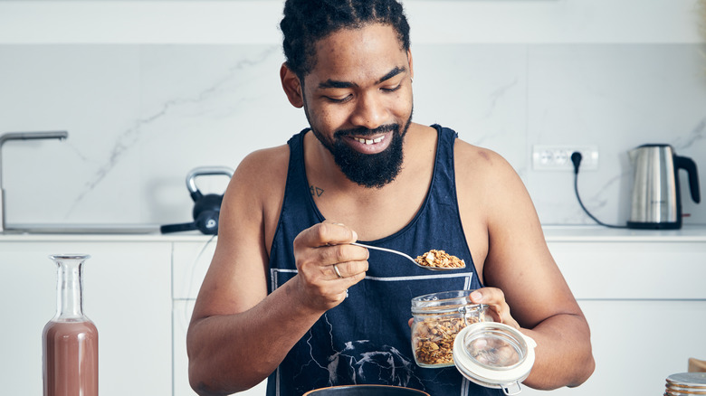 man adding nuts to his oatmeal