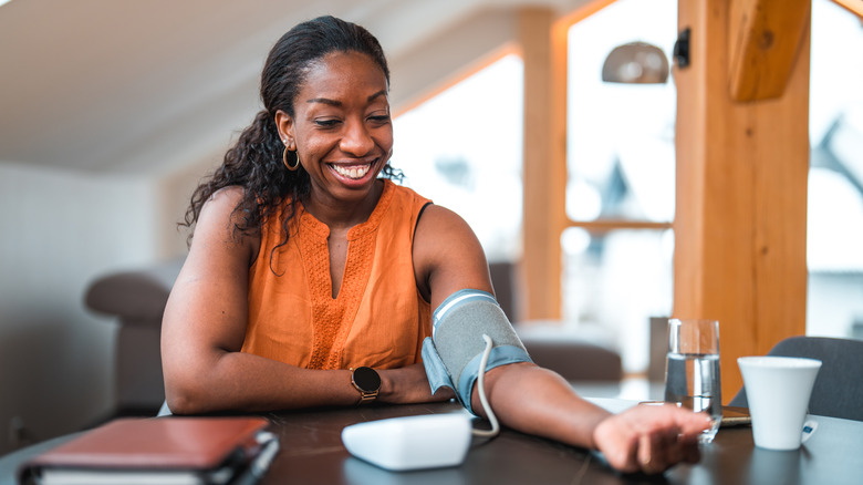 woman checking her blood pressure at home