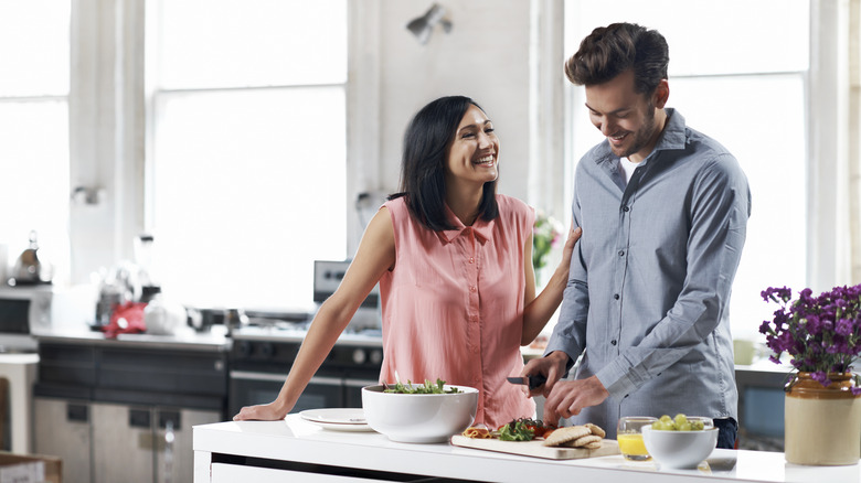 couple fixing healthy dinner