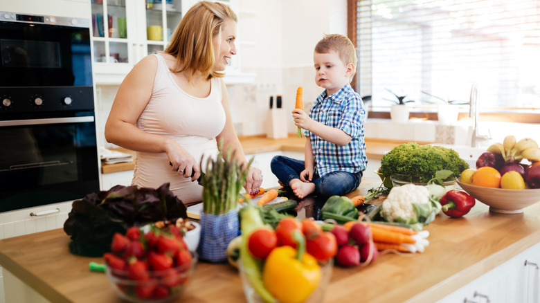 mother and child eating vegetables