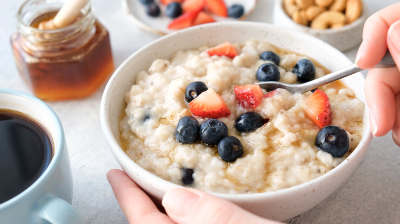 bowl of oatmeal with strawberries and blueberries
