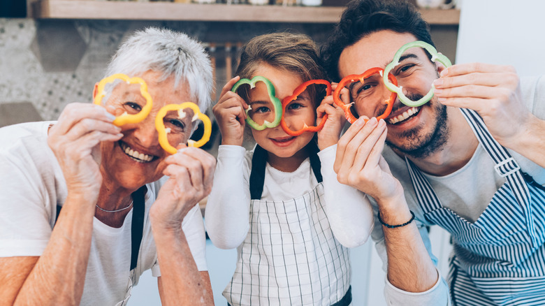family holding pepper cutouts over eyes